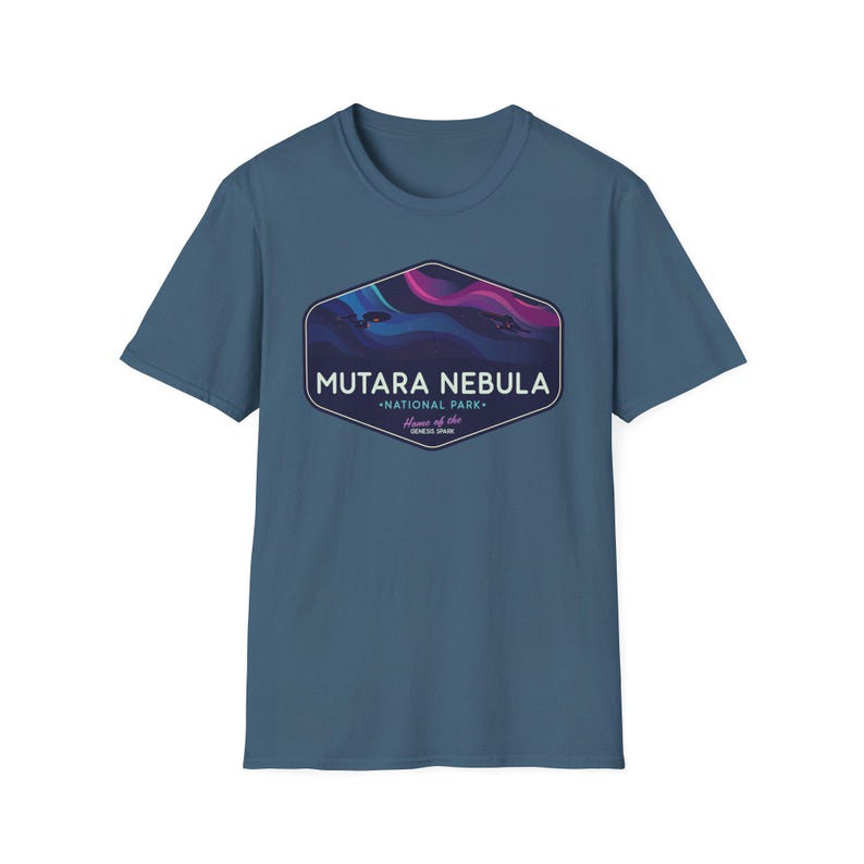May include: A blue t-shirt featuring a graphic of the Mutara Nebula National Park. The graphic is a hexagon shape with the words "Mutara Nebula National Park" and "Home of the Genesis Span" in white text. The graphic has a purple and blue nebula design.