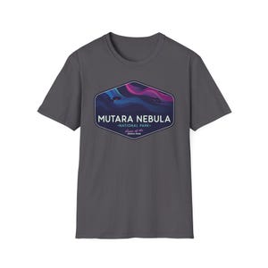 May include: A charcoal gray t-shirt featuring a hexagonal graphic with the words "MUTARA NEBULA - NATIONAL PARK" and "Home of the GENESIS SPAN". The graphic depicts a colorful nebula scene with shades of blue, purple, and pink.