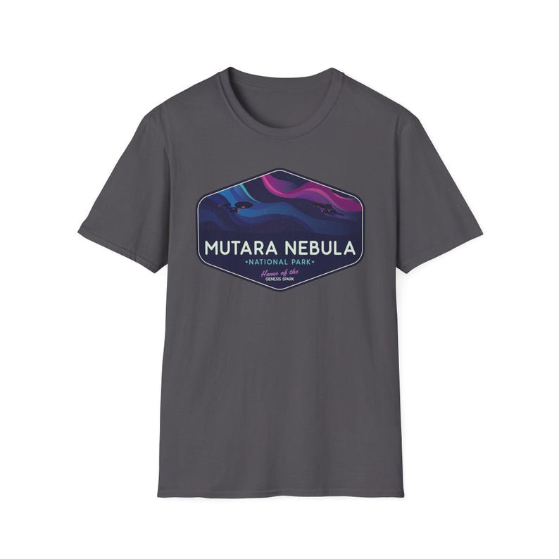 May include: A charcoal gray t-shirt featuring a hexagonal graphic with the words "MUTARA NEBULA - NATIONAL PARK" and "Home of the GENESIS SPAN". The graphic depicts a colorful nebula scene with shades of blue, purple, and pink.