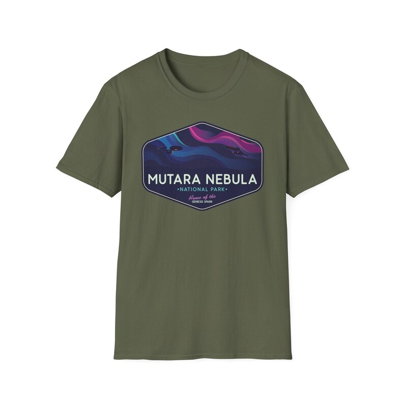 May include: Olive green t-shirt featuring a hexagonal graphic with the text "MUTARA NEBULA - NATIONAL PARK - Home of the GENESIS SPAN." The graphic depicts a colorful nebula scene in shades of blue, purple, and pink.