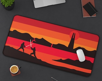 May include: A rectangular mouse pad featuring a silhouette of a lightsaber battle against a sunset backdrop. The design includes two figures with glowing lightsabers, a tower, and a red sun. The color scheme is primarily red, orange, and black.