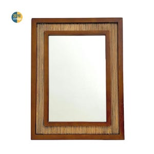 May include: Rectangular mirror with a dark brown wooden frame. The frame has a bamboo-style border around the mirror's edge. The upper left corner has a circular sticker with the text "20 90 vintage".