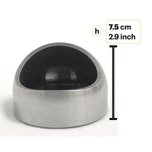 May include: A silver-colored, dome-shaped object with a smooth, dark interior cavity. A vertical measurement line next to the object indicates a height of 2.9 inches, labeled with the letter h and the text 7.5 cm 2.9 inch.
