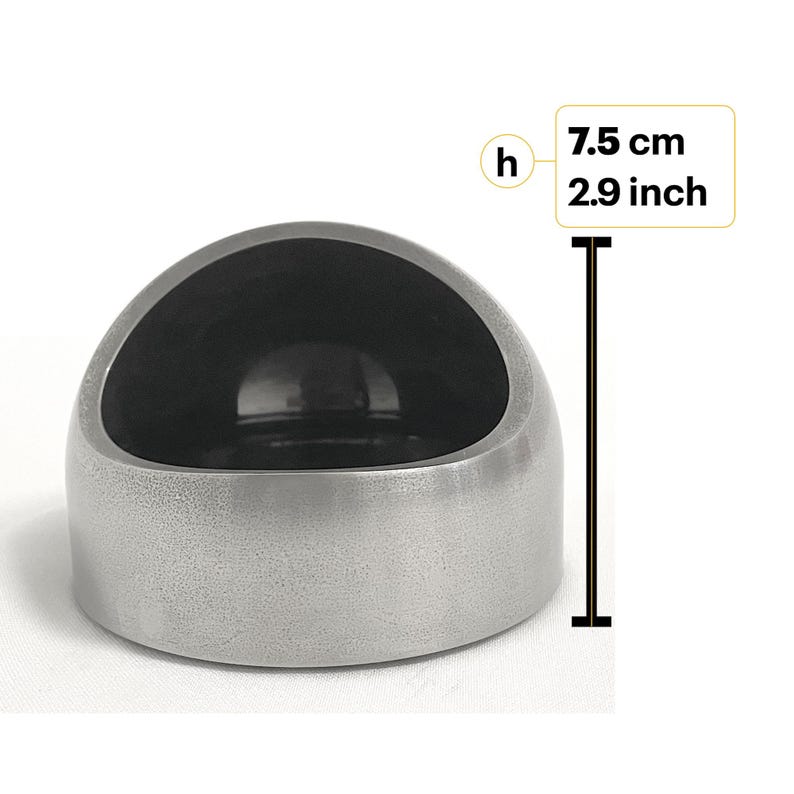 May include: A silver-colored, dome-shaped object with a smooth, dark interior cavity. A vertical measurement line next to the object indicates a height of 2.9 inches, labeled with the letter h and the text 7.5 cm 2.9 inch.