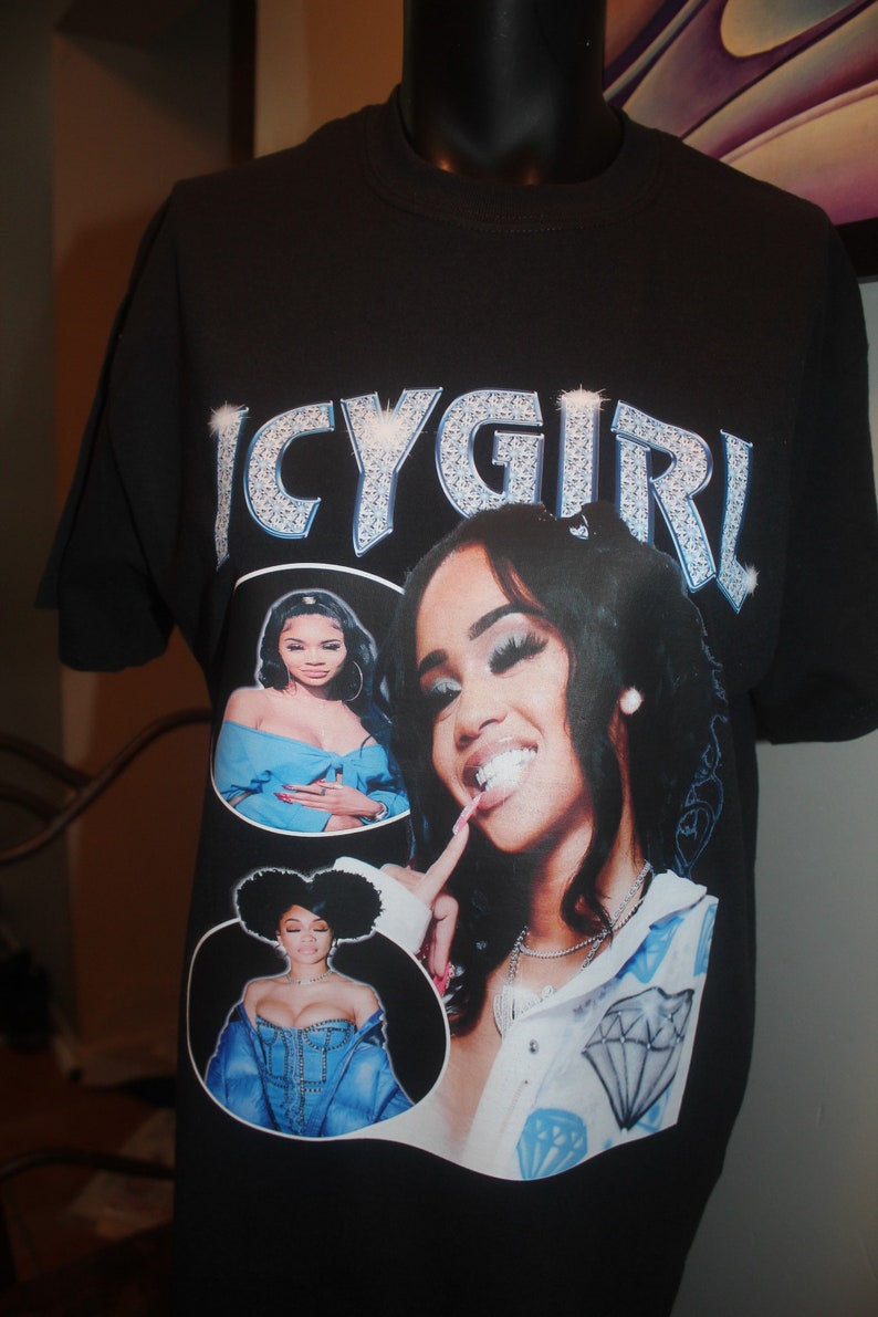 May include: Black t-shirt with a graphic print of a woman with a diamond necklace and the text "ICYGIRL" in rhinestones.