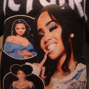 May include: Black t-shirt with a white diamond-encrusted "ICY GIRL" graphic. The shirt features three images of women wearing denim jackets and blue clothing.