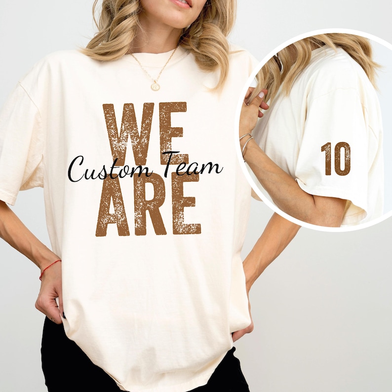 May include: A white t-shirt with the text "We Are Custom Team" in brown distressed lettering. The shirt also has a brown number 10 on the sleeve.