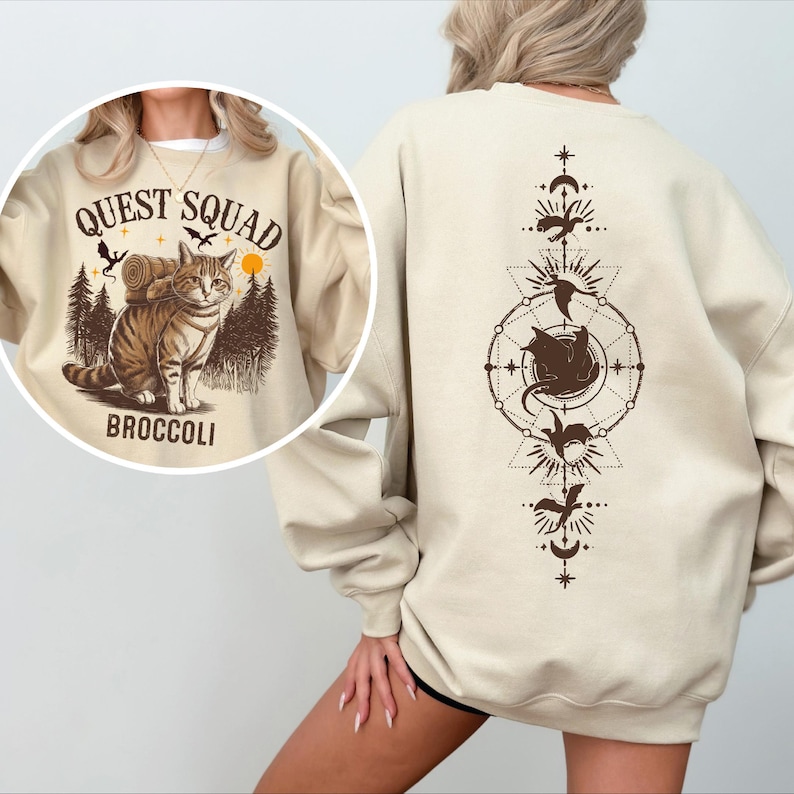 a woman wearing a sweatshirt with a picture of a cat on it