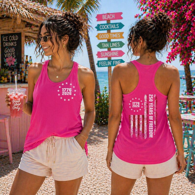 A woman wearing a pink tank top with the text "1776" and "50 YEARS OF FREEDOM" printed on it, standing in front of a beach sign.