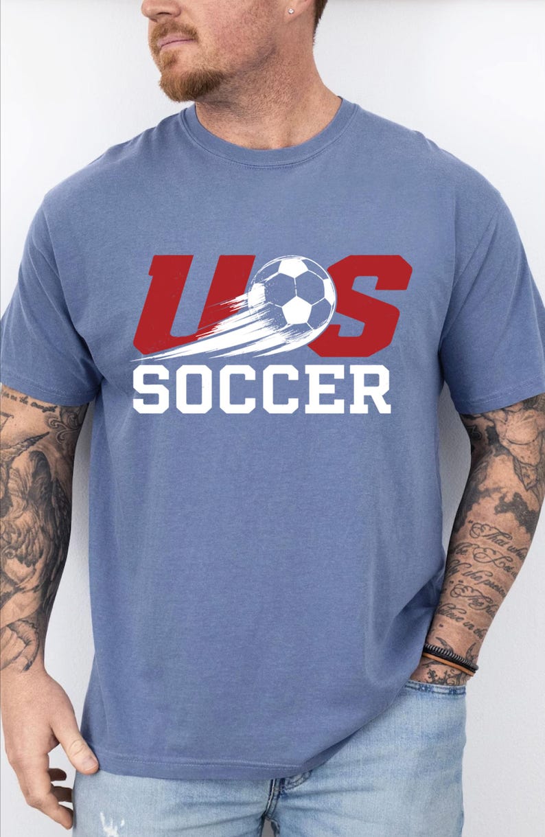 A man wearing a blue t-shirt with the text "US SOCCER" printed on it.