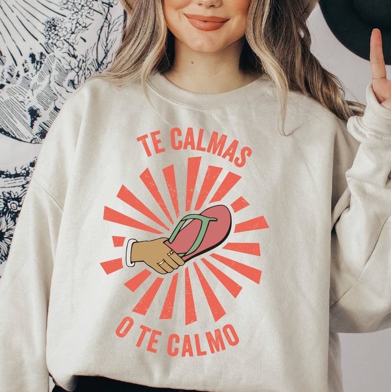 a woman wearing a sweatshirt that says te calmas o'te calmo