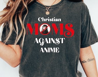 May include: A dark gray t-shirt with the text "Christian Moms Against Anime" in white and red letters. A cartoon image of a girl with a red circle and line through it is in the middle of the word "Moms".