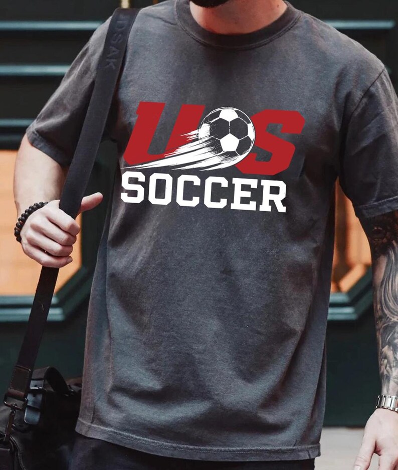 A person wearing a gray t-shirt with the text "LESS THAN 500" printed on it.