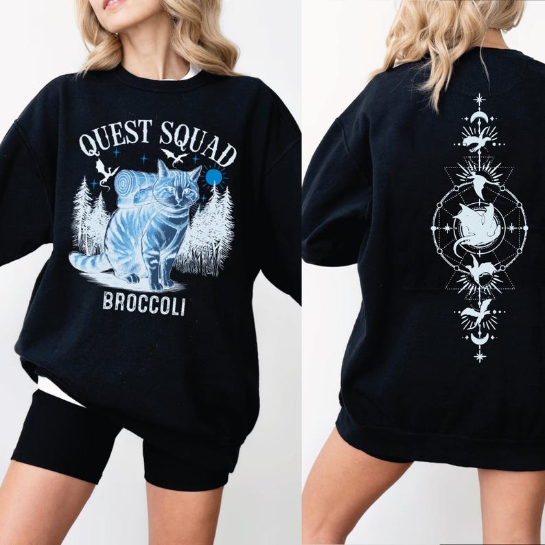 a woman wearing a black sweatshirt with an image of a cat on it