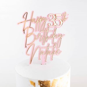 May include: Pink and gold acrylic cake topper with the text "Happy 35th Birthday Natalie".