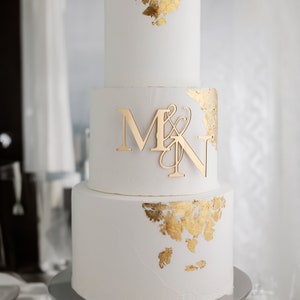 tall white gold 3 tier wedding cake with monogram initials charm in gold mirror