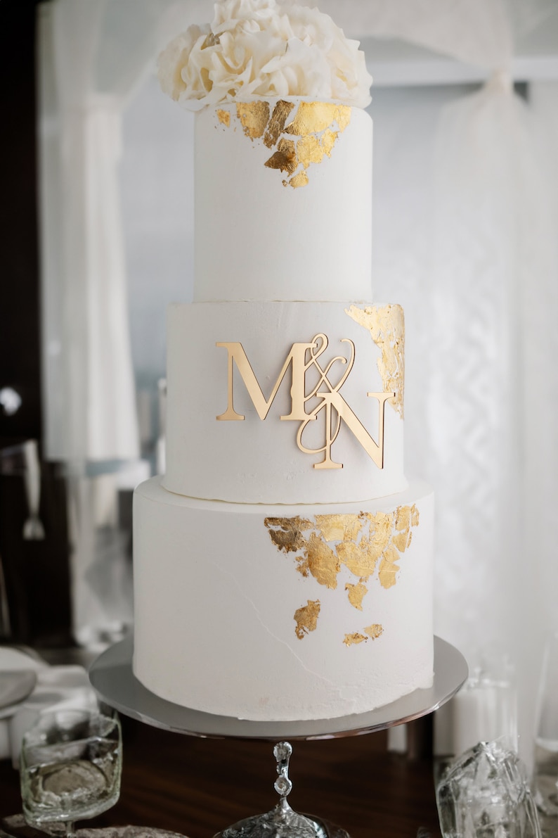 tall white gold 3 tier wedding cake with monogram initials charm in gold mirror