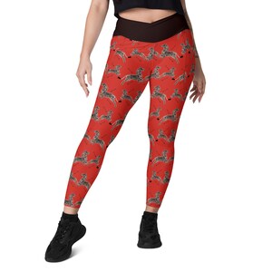 May include: Red leggings with a black waistband and a zebra print pattern.