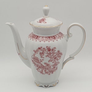 May include: White porcelain coffee pot with a red floral design and gold trim. The pot has a lid with a knob on top.