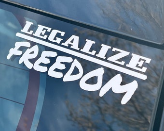 May include: A white vinyl sticker on a car window that reads "Legalize Freedom" in a bold, blocky font.