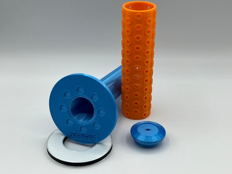 May include: A blue and orange 3D printed set of parts for a 3D printer. The set includes a blue base with a hole in the center, a blue cap, a blue and orange tube, and a white ring with black trim.