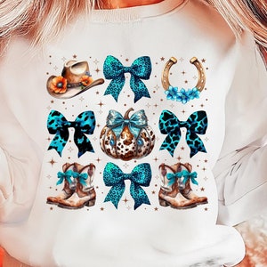 May include: White sweatshirt with a blue, brown, and gold design featuring cowboy boots, a cowboy hat, a pumpkin, and bows.