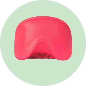 May include: A bright pink sleep mask made of soft, textured fabric. The mask is contoured to fit comfortably over the eyes.