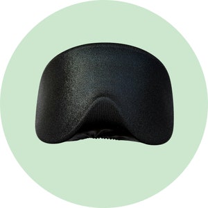 May include: A black sleep mask with a textured surface.