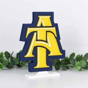 North Carolina A&T State University Aggies decoration with ivy behind it, right side.