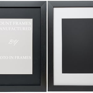 May include: Two black picture frames with white mounts. The frame on the left has the text "MOUNT FRAMES MANUFACTURED BY PHOTO IN FRAMES" printed on the mount.