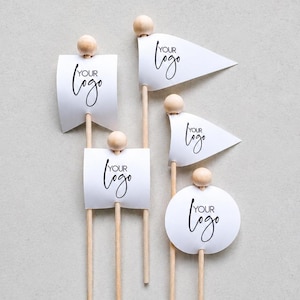 May include: Five wooden sticks topped with small round wooden beads, each featuring a white paper attachment in various shapes including rectangular, triangular, and circular. Each paper piece displays the black printed text YOUR LOGO.