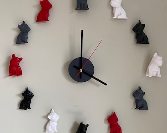 May include: A clock with a black face and hands, surrounded by 12 small, geometric dog figurines in red, white, and black.