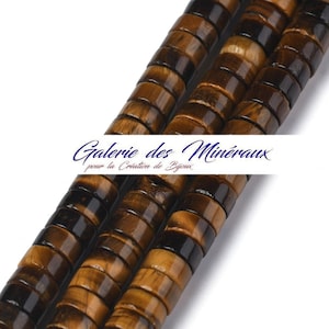 May include: Three strands of tiger's eye beads, each bead is a cylinder with a brown and gold color pattern. The beads are stacked on top of each other.