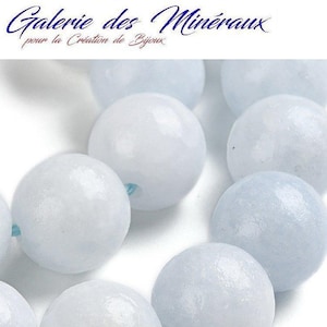 May include: A strand of light blue gemstone beads. The beads are round and smooth, with a slightly iridescent finish. The beads are strung on a thin, clear thread.