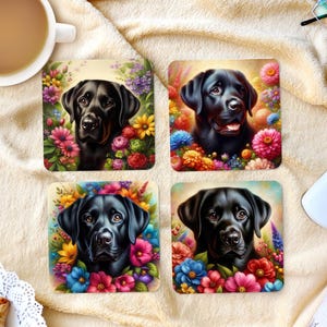 May include: Four square coasters featuring portraits of a black Labrador Retriever surrounded by colorful flowers. The dog's image is centered on each coaster, with a variety of blooms in shades of pink, blue, yellow, and red.