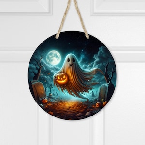 May include: A round, wooden Halloween door hanger with a spooky scene. A white ghost with a friendly face holds a jack-o-lantern in a dark, foggy forest setting.  The scene is surrounded by tombstones and pumpkins.