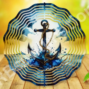 May include: A blue and gold metal wind spinner with a watercolor design of an anchor in the ocean. The anchor is black with a gold chain.