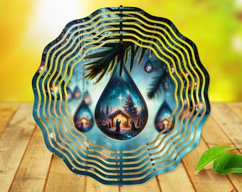 May include: A blue and gold metal wind spinner with a teardrop design. The teardrop features a winter scene with a star, a Christmas tree, and a small house. The wind spinner has multiple layers and is designed to spin in the wind.