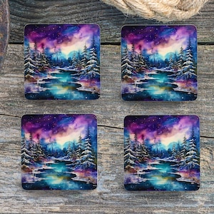 May include: Set of four square coasters featuring a watercolor painting of a winter scene with a river, trees, and a starry sky. The colors are purple, blue, and white.