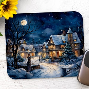 May include: A winter scene mousepad with a snowy village under a full moon. The houses are lit up with warm yellow lights and there are trees covered in snow. The mousepad is made of a soft, durable material and is perfect for adding a touch of winter magic to your desk.