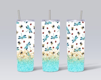 May include: Three stainless steel tumblers with lids and straws. Each tumbler features a white background with a pattern of blue dragonflies, yellow bees, and red ladybugs. The bottom of each tumbler has a gradient of gold glitter fading into turquoise glitter.