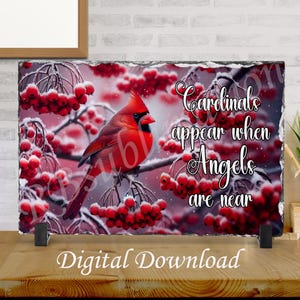 May include: A rectangular decorative stone with a vibrant image of a red cardinal perched on a branch with red berries. The text "Cardinals appear when Angels are near" is displayed. The words "Digital Download" are at the bottom.