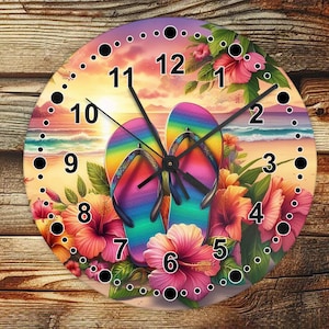 May include: A colorful clock with a beach theme. The clock face features a rainbow-colored flip-flop design with a black clock hand. The clock is surrounded by tropical flowers and a sunset background.
