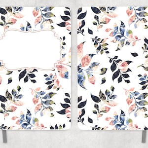 May include: A white notebook cover with a floral pattern in shades of blue, pink, and green. The cover has a blank label with a decorative border.