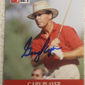 May include: Official PGA Tour card featuring Gary Player. The card shows a man in a red polo shirt and straw hat holding a golf club. The card has the Pro Set logo and the text "GARY PLAYER" at the bottom.
