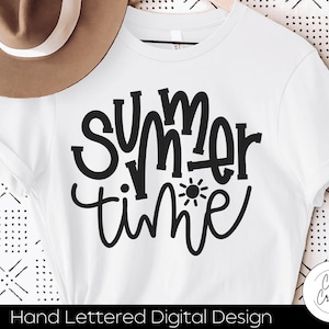 May include: White t-shirt with black text that says "Summer time" with a sun graphic. The text is hand-lettered and has a casual, summery feel.