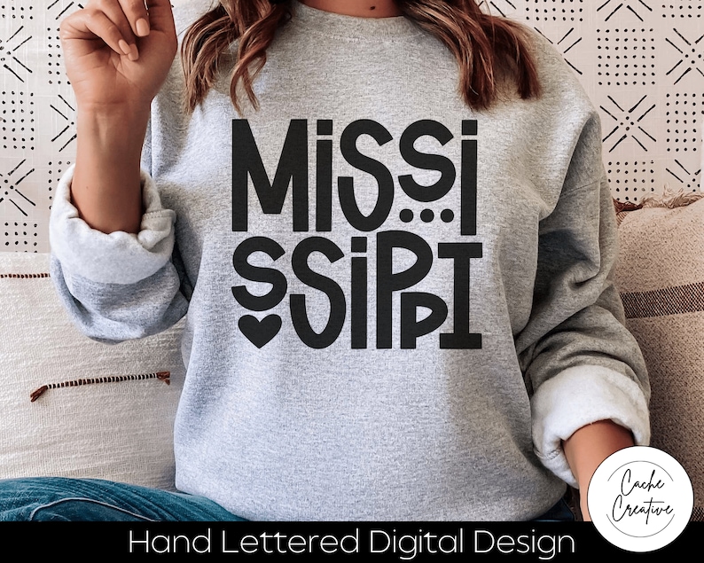 May include: A gray sweatshirt with a black hand-lettered design that says "MISSISSIPPI" with a heart in the middle of the word "MISSI".