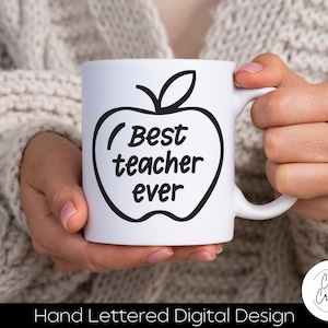 May include: White ceramic mug with a black apple outline and the words "Best teacher ever." The mug has a handle and is held by a person. The bottom of the image reads "Hand Lettered Digital Design."