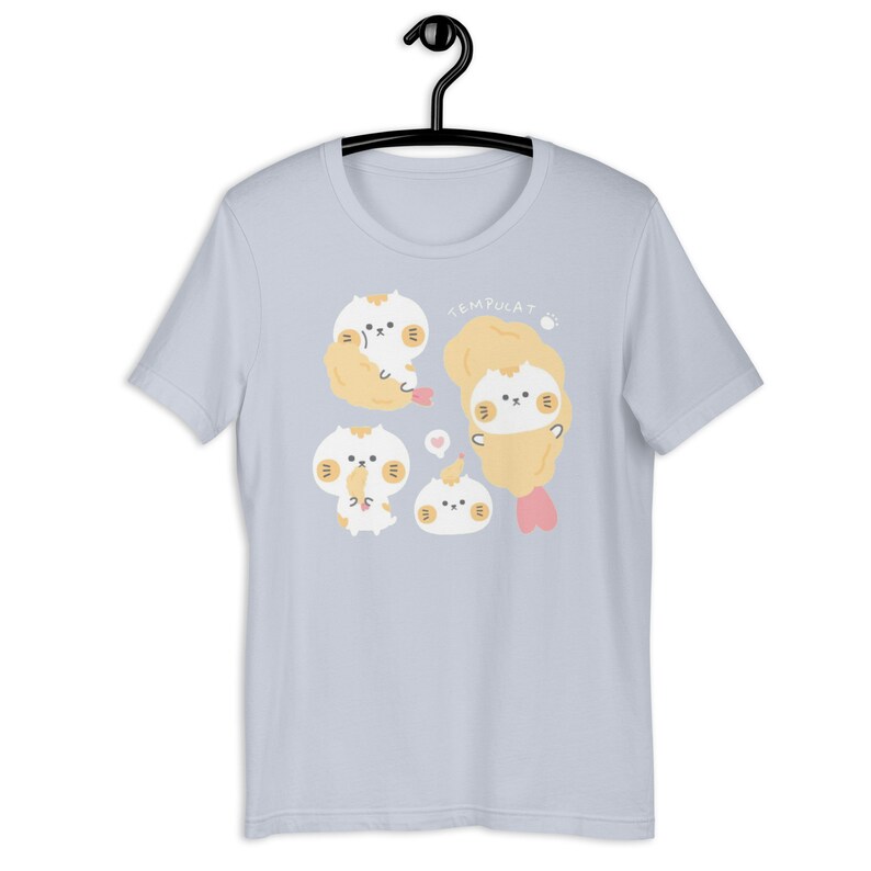 light blue tee shirt with a kawaii drawn cat design surrounded by tempura shrimp very kawaii and harjuku style