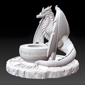 May include: A white dragon sculpture with intricate details. The dragon has large wings, a detailed body, and is perched near a decorative bowl. The sculpture sits on a round base with carved patterns, creating a fantasy-themed decorative piece.